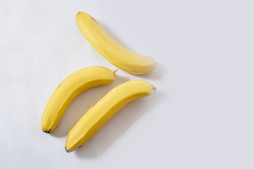 A high angle shot of a bunch of bananas isolated on a white background