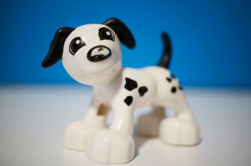 A closeup shot of a Lego Duplo brand toy figurine with black spots
