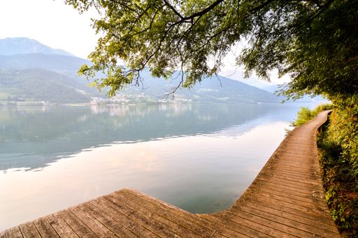 The Lake Lago di Caldonazzo on the Background of Dolomites in Italy