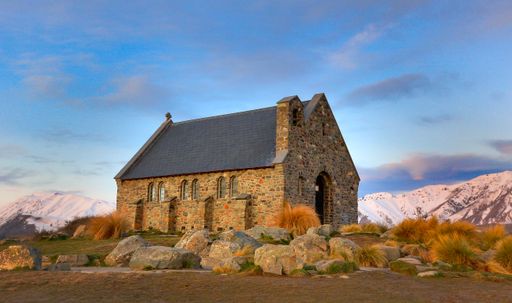 A single-storey old-fashioned brick building near the mountains