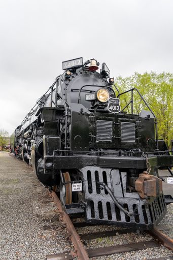 The old and historic steam train on track in a museum