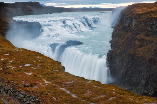 A scenic view of Gullfoss Waterfall in Iceland flowing down the cliffs