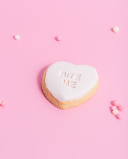A closeup of heart-shaped Valentine's day cookies on a pink background