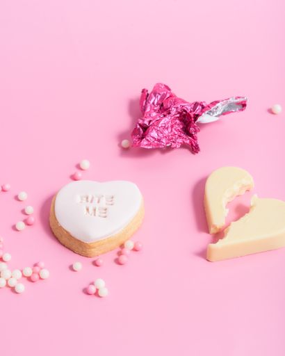 A closeup of heart-shaped Valentine's day cookies on a pink background
