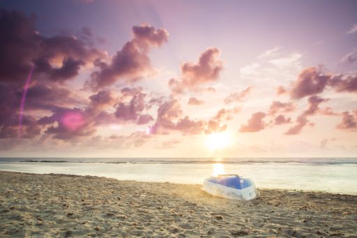 A landscape shot of a mesmerizing shoreline under a a peachy purple sky