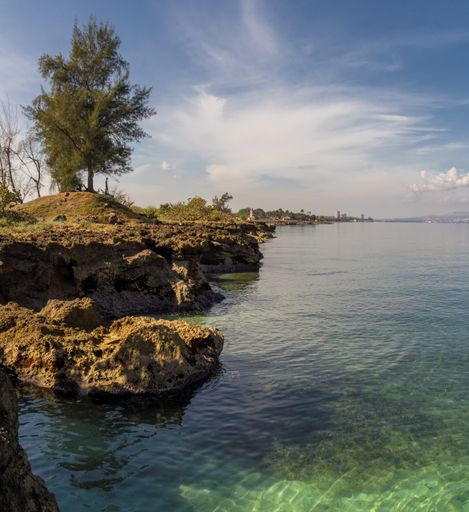 A scenic view of Matanzas Bay in Matanzas, Cuba on cloudy sky background