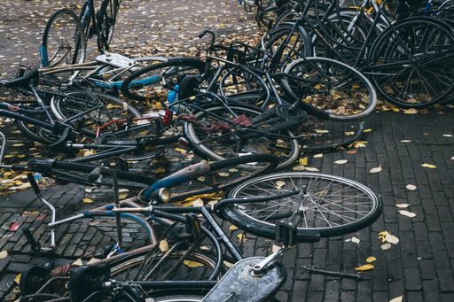 A high angle shot of bicycles parked in the street in the autumn