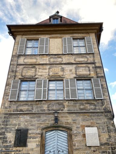 A vertical shot of an old building on a cloudy sky background in Bamberg, Germany