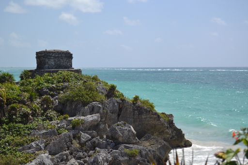 A landscape of the Tulum Archaeological Zone surrounded by the sea in Mexico