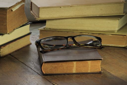 A closeup of glasses on a book