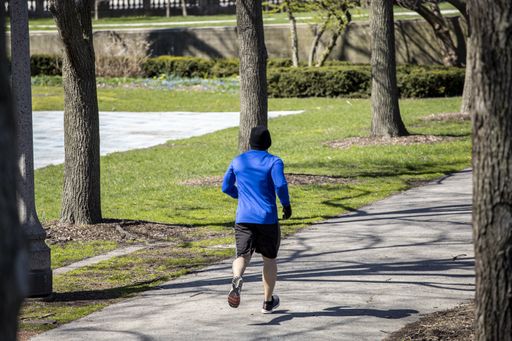 People are enjoying walks in the parks of downtown Chicago wearing masks and gloves despite the fears of Covid-19 corona virus. the city is shutdown