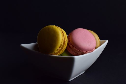 A close-up shot of colorful macaroons isolated on a black background