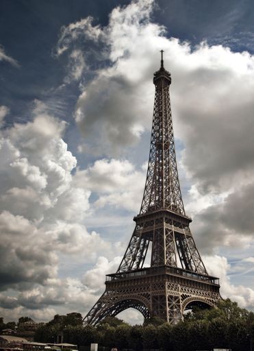 Eiffel tower with cloudy sky. Photograph taken from the river Seine