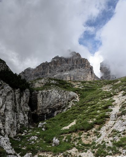 A scenic view of a path to Tre Cime di Lavaredo in the north of Italy against a cloudy sky