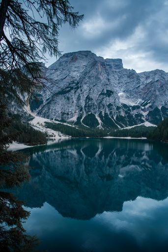 A scenic view of Lake Braies in front of an alpine mountain in Prags Dolomites in South Tyrol, Italy