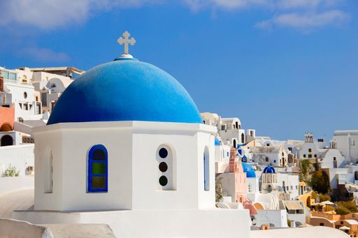 A closeup shot of Greek church of St. Nicholas with blue dome, Oia, Santorini Thira, Greece