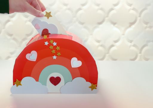 A closeup shot of the hand dropping the letter into mailbox for kids