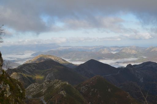 An aerial shot of mountain range under the cloudy sky