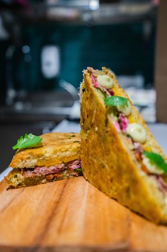A closeup vertical shot of a delicious sandwich on a wooden chopping board