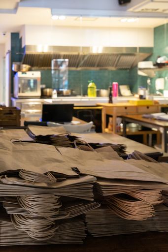 A closeup vertical shot of a pile of paper bags on a table