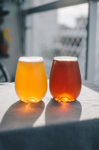 A vertical selective focus shot of two glasses of wheat beer