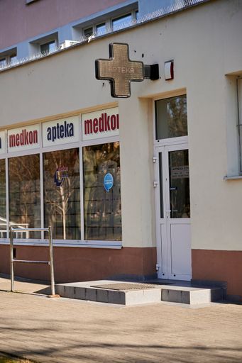 A vertical shot of the front entrance of Medkon pharmacy in the Rataje district