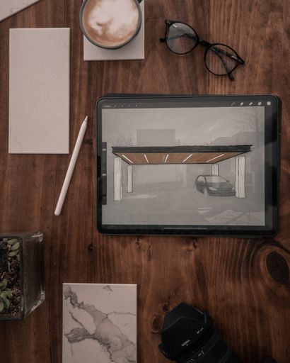 A wooden desk with multiple objects on it