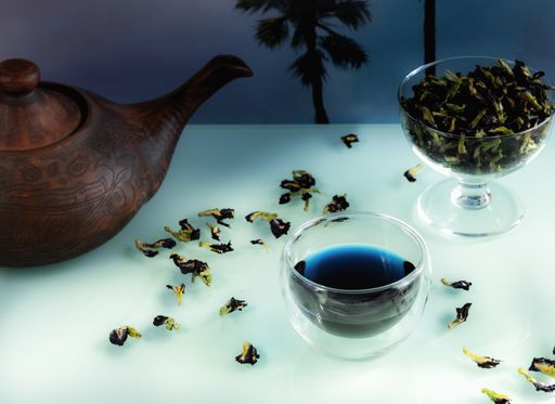 A closeup shot of butterfly pea flower tea on the white table
