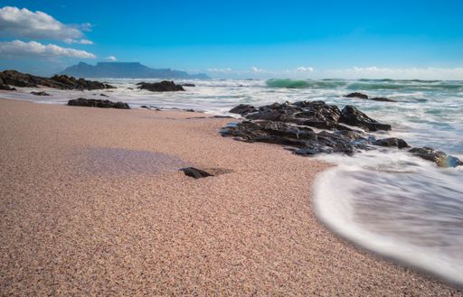 The beach surrounded by the sea with long exposure under the sunlight at daytime - great for wallpapers