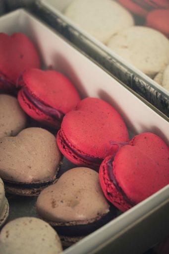 A vertical high angle shot of heart-shaped macaroons in the shop