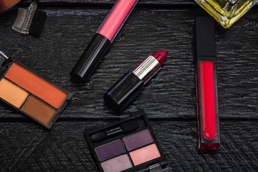 An assorted beauty cosmetics on a black surface