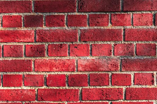 A reddish stone wall as a background.