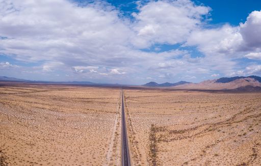 The aerial view of the road passing through the desert. Harquahala Mountains, Arizona, United States.