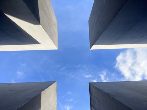 A low angle view of tall buildings under the blue sky
