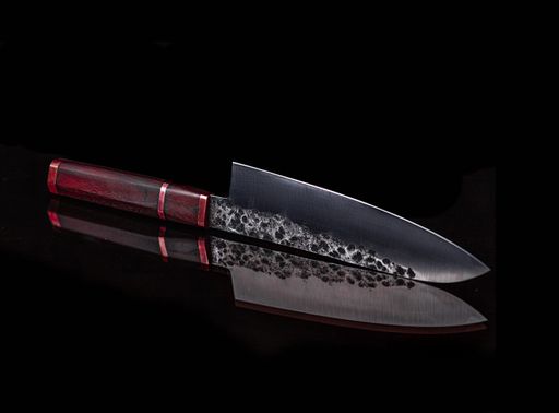 A sharp knife with a wooden handle and its reflection on a black surface