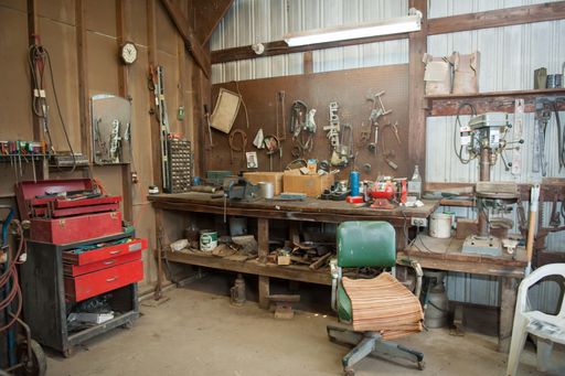 A wide shot of an old barn' s workbench with different types of tools