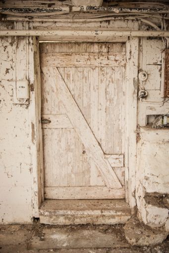 A wooden door of an old rusty family barn in the rural countryside area of Pennsylvania