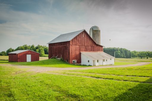 A beautiful old barn with a milkhouse in a field of rural areas of Pennsylvania