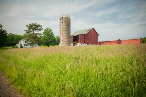 A beautiful old barn with a milkhouse in a field of rural areas of Pennsylvania