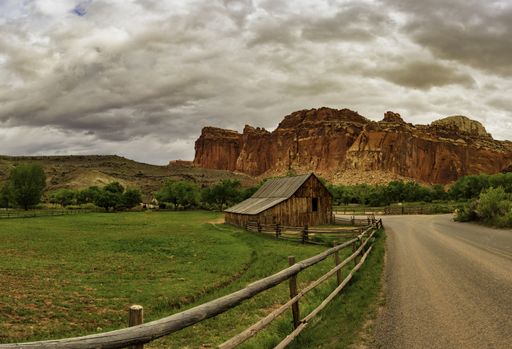 A view of Fruita Barn in the rocky landscape under the cloudy sky, Capitol Reef National Park