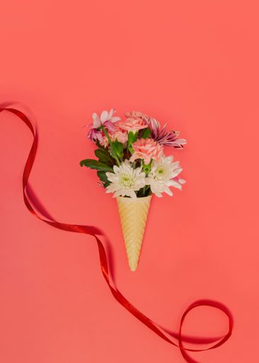 A creative spring flowers bouquet on ice cream waffle cornet