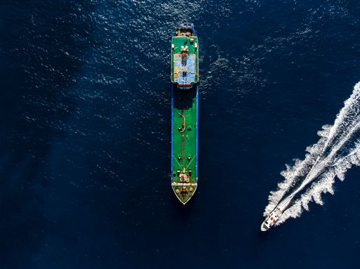 A top view shot of a boat and a ship