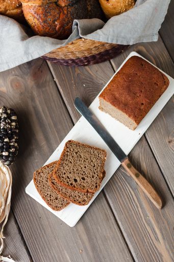 A flat lay of slices of bread in a white tray on a wooden background