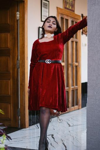 A vertical shot of a beautiful indian woman in red dress
