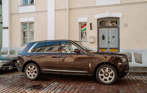 A beautiful shot of a brown Rolls Royce Cullinan in the Old Town of Tallinn, Estonia