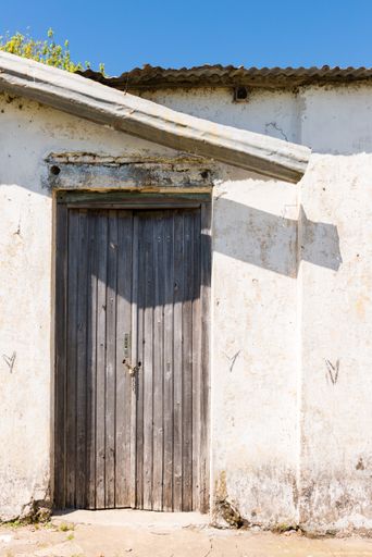 A view of the door of an old building on a sunny day