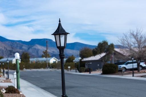 The lamp post on a quiet residential street with mountains in the background