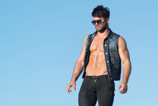 Handsome Man Standing Strong and Posing at Outdoors Wearing Black Jeans - Background of Sky