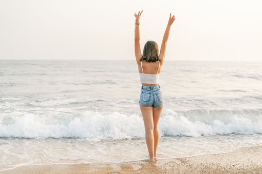 The Woman on the shore of the beach from behind