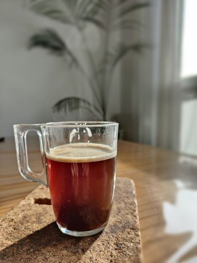 The close-up shot of glass with a coffee in it